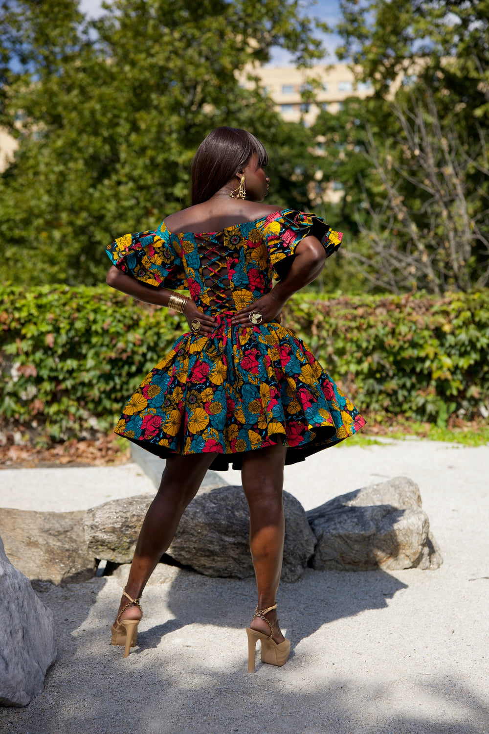 Short African print peplum skirt with dramatic sleeves corset top.