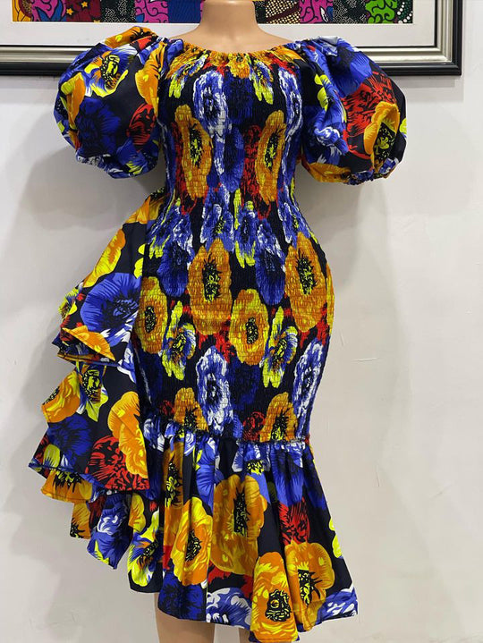 African print smoke body-con dress with puffy sleeves and ruffles on the side.