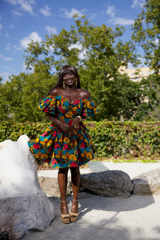 Short African print peplum skirt with dramatic sleeves corset top.