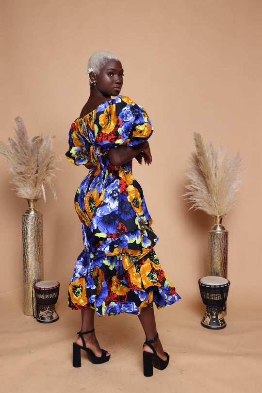 African print smoke body-con dress with puffy sleeves and ruffles on the side.