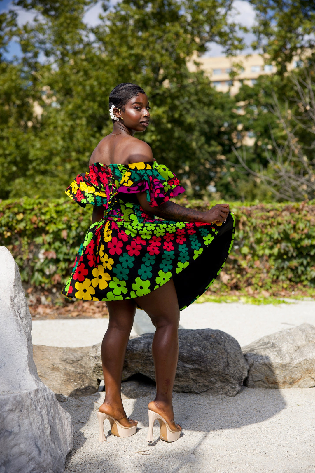 Short African print peplum skirt with dramatic sleeves corset top.