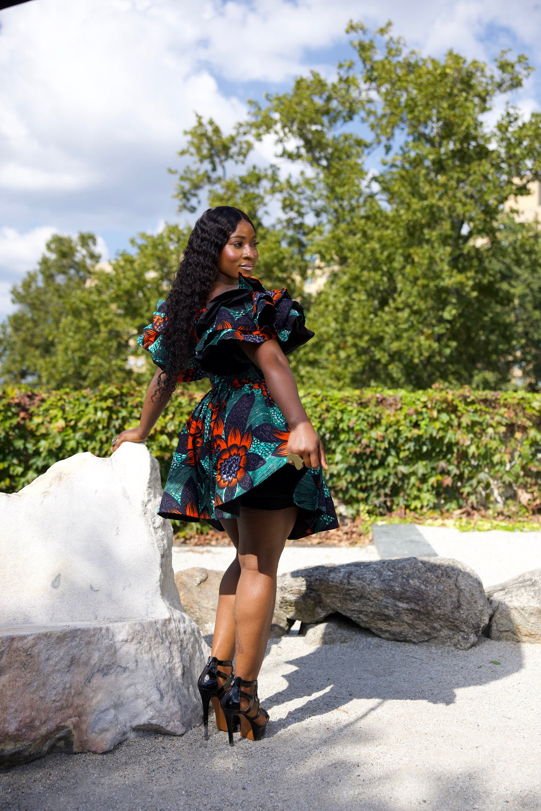 Short African print peplum skirt with dramatic sleeves corset top.