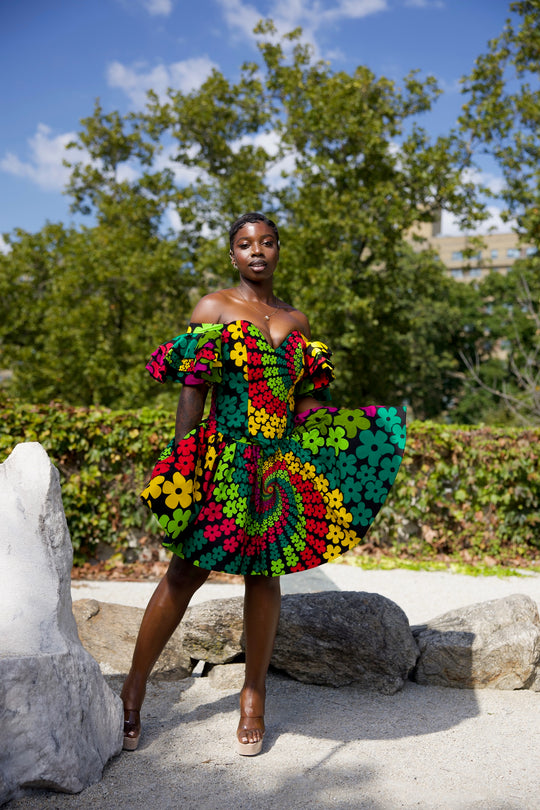 Short African print peplum skirt with dramatic sleeves corset top.