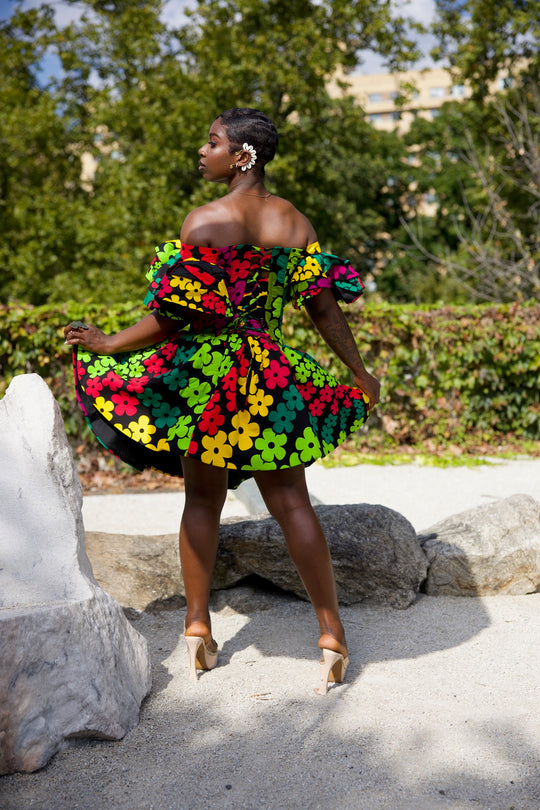 Short African print peplum skirt with dramatic sleeves corset top.