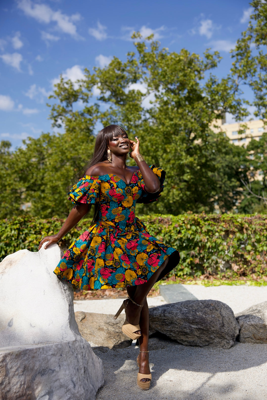 Short African print peplum skirt with dramatic sleeves corset top.