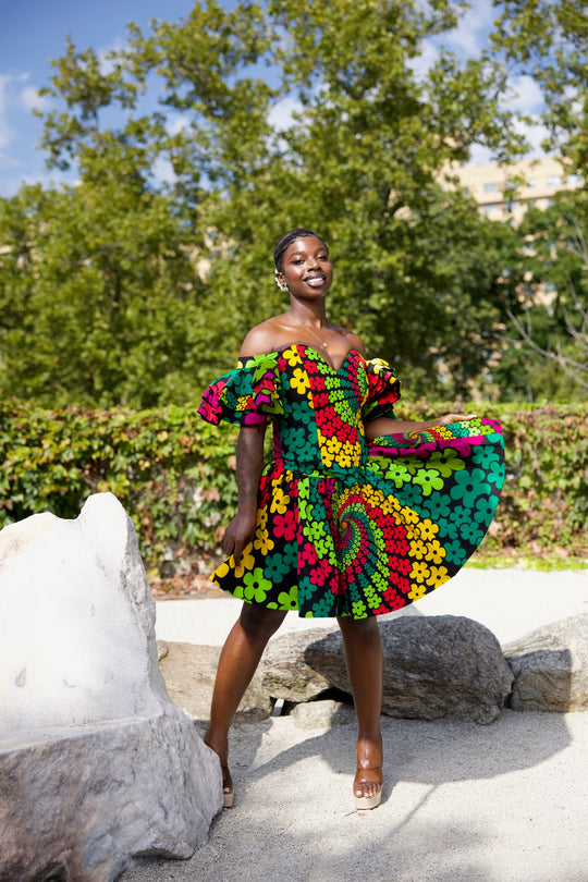 Short African print peplum skirt with dramatic sleeves corset top.