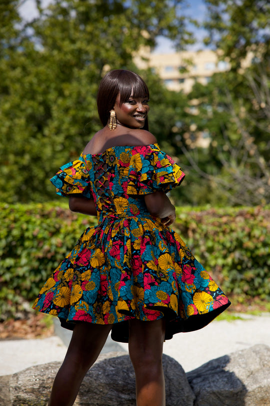 Short African print peplum skirt with dramatic sleeves corset top.