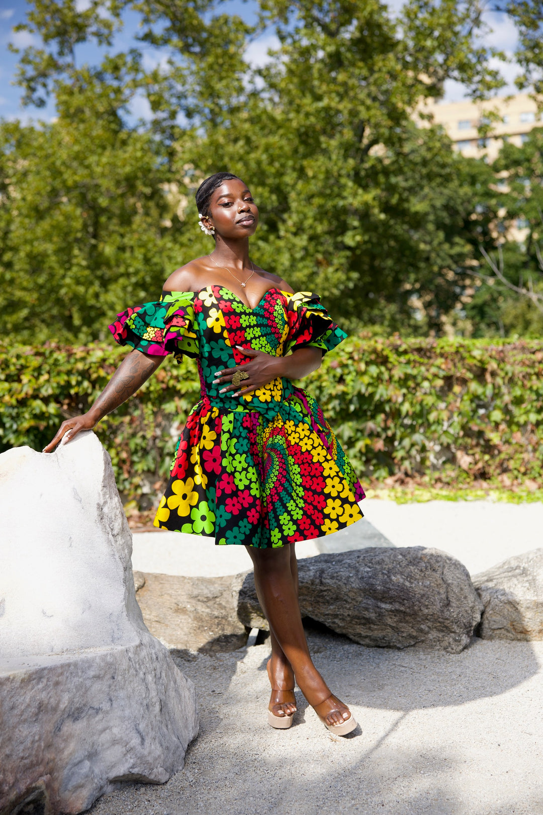 Short African print peplum skirt with dramatic sleeves corset top.